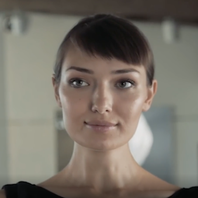 woman looking into mirror